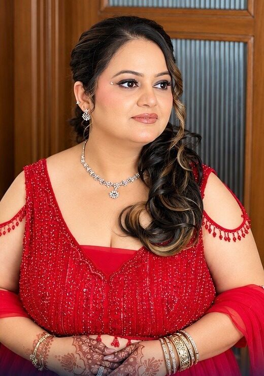 Party look in a red beaded outfit with soft curls