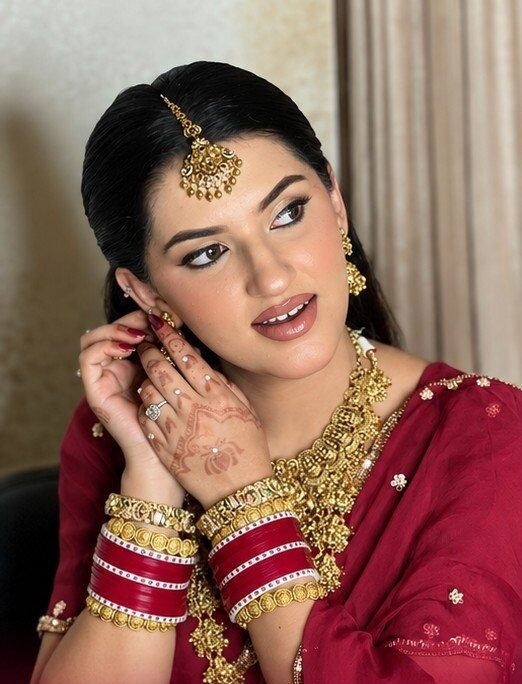 Reception look in maroon with gold temple jewellery